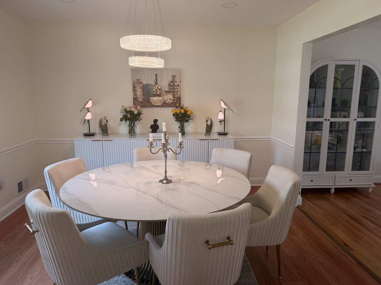 Elegant modern dining room with marble table and chandelier